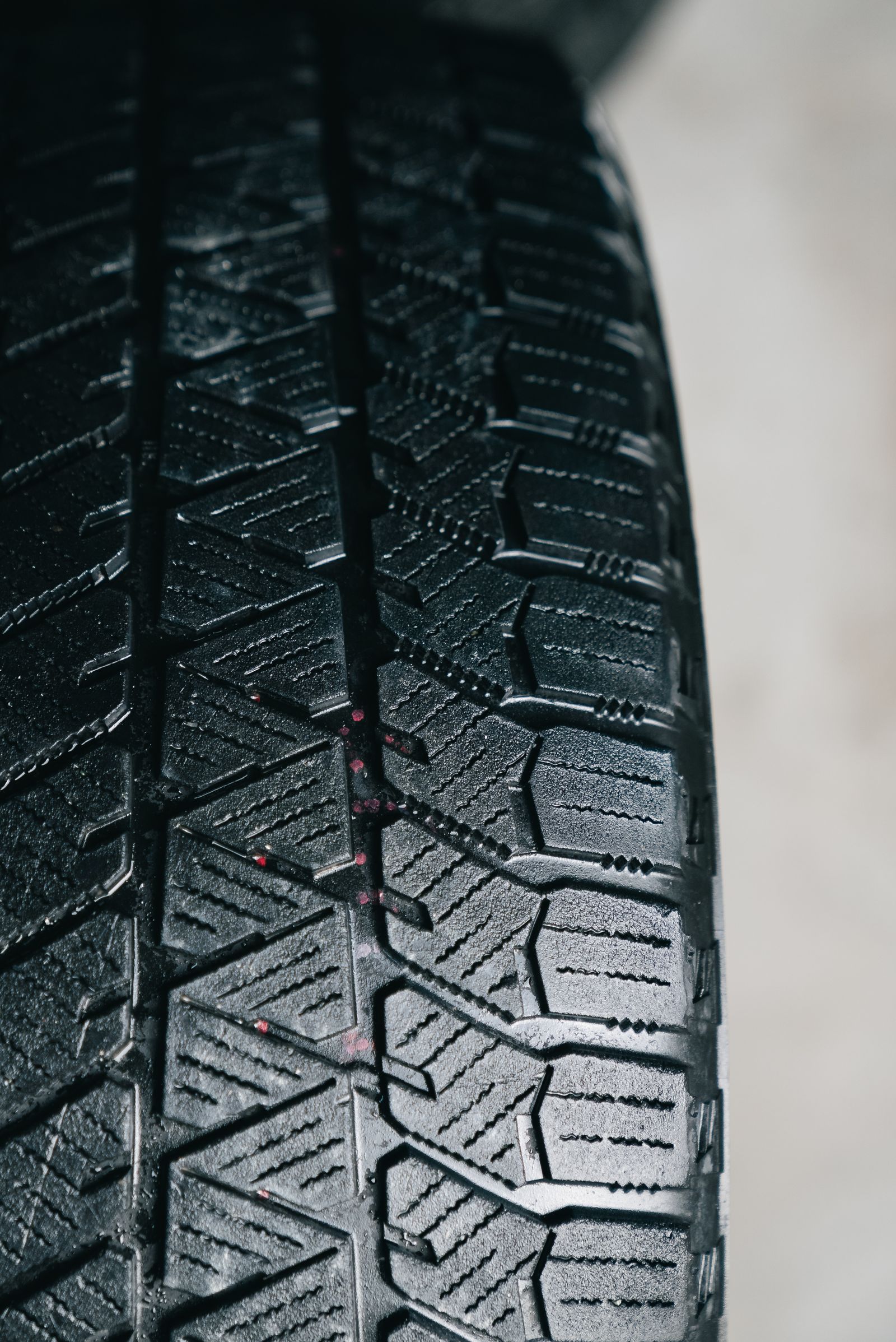 Close-up of a winter tire tread with siping pattern