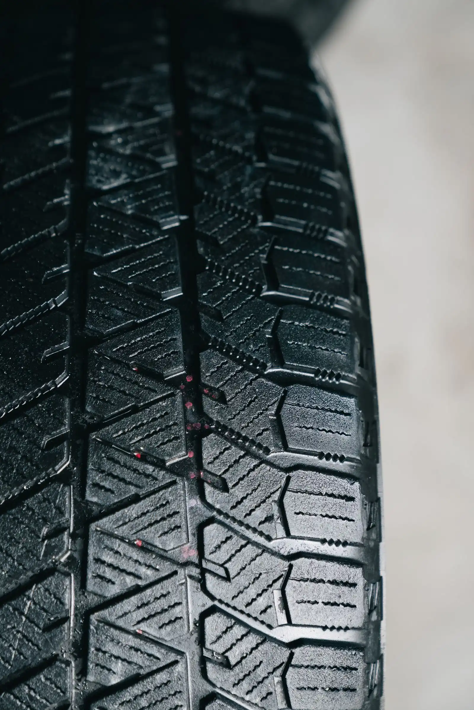 Close-up of a winter tire tread with siping pattern